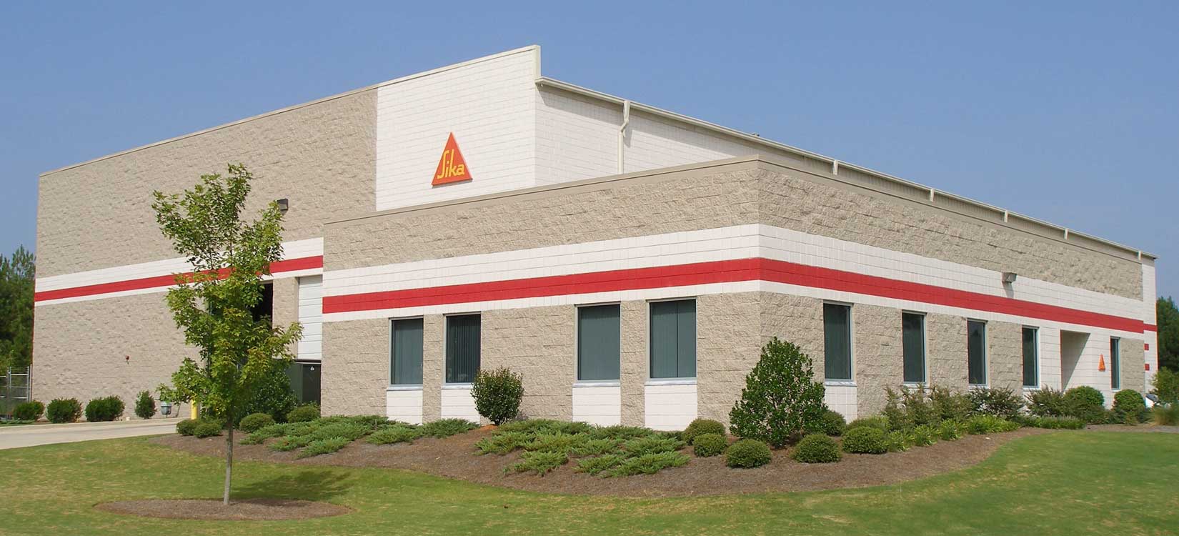 Image of Sika just outside of Atlanta GA.  This is a pre-engineered metal building with a metal roofing system.  Fox Building Company is a commercial construction general contractor specializing in furnish and erect pre-engineered metal building by Nucor Building Systems and Design Build construction.