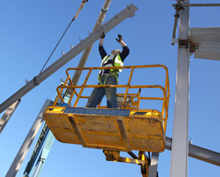 Image of one of Fox Building Company’s custom-
designed steel erection package. Furnish and erect is the most cost effective and easy single-source solution available. This image shows a steel building erector creating a customized steel solution just the way the client wants it. 
