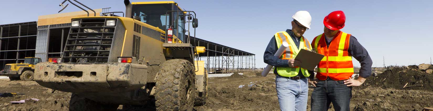 Image of a construction worker on a lift at a furnish and erect construction site This construction employee is trained in the construction of pre-engineered metal building such as Nucor Steel Building Systems.